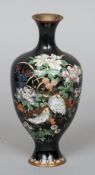 An Oriental cloisonne vase
Of flared bulbous form, decorated with butterflies and birds amongst