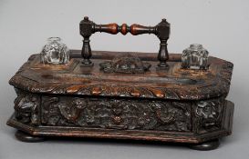 A 19th century carved oak desk stand
The turned carrying handle above the main body with pen