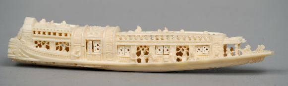 An ivory group
Carved as figures aboard a traditional boat.  23 cms long. CONDITION REPORTS: