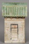 A Chinese Tang Dynasty pottery model of a house
With a green glazed pitched roof above the central