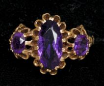 A 9 ct gold amethyst set three stone ring
The central oval facet cut amethyst flanked by two smaller