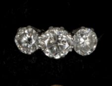 An 18 ct gold three stone diamond ring
The central claw set stone approximately 0.75 carat flanked