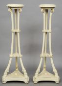 A pair of 19th century carved wooden torcheres
Each circular top supported by scroll headed