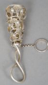 A white metal posy holder
The pierced basket filigree worked, the loop handle entwined.  11.5 cm