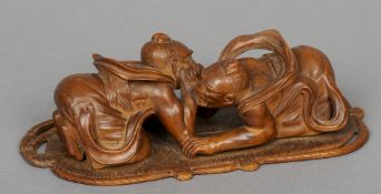 A late 19th/early 20th century Japanese carved wooden model of arm wrestlers
The two figures