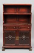 A mahogany waterfall side cabinet
The three quarter galleried top above two shelves over two drawers