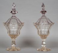 A pair of 19th century cut crystal glass lidded sweetmeats
Each lid of knopped faceted form, the