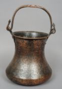 An early Islamic copper pail
Of waisted cylindrical form with a swing handle decorated in the
