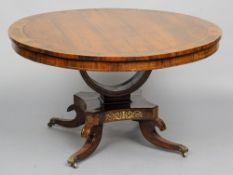 A Regency brass inlaid rosewood tilt top breakfast table
The circular brass inlaid top supported