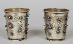 A pair of 19th century Turkish silver beakers
Each set with various cabochon stones and with