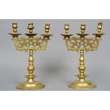A pair of French brass three branch candelabra
Each with pierced cast panels with mythical
