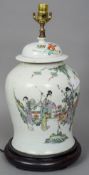 A Chinese porcelain vase and cover
Decorated with female figures in a garden with a deer, opposing