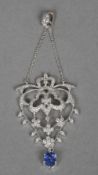 An 18 ct white gold, diamond and sapphire set pendant
Of pierced scrolling floral form, set with a