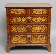 An 18th century inlaid walnut chest of drawers
The marquetry inlaid rectangular top above an