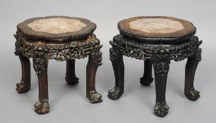 A pair of late 19th/early 20th century Chinese marble topped carved hardwood urn stands
Each