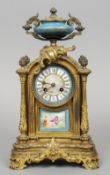 A 19th century Continental porcelain mounted ormolu mantel clock
The urn form finial above the