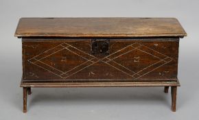 A 18th century oak plank coffer
The hinged moulded rectangular lid enclosing a candle box, the front