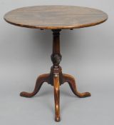 An 18th century mahogany tilt top tripod table
The hinged single plank top above the turned columns,