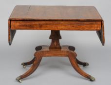 A 19th century inlaid rosewood sofa table
The twin flap rectangular top above two frieze drawers,