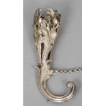 A white metal posy holder
The pierced basket floral cast, the handle a stylised dolphin.  11 cm