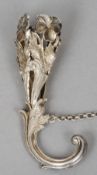A white metal posy holder
The pierced basket floral cast, the handle a stylised dolphin.  11 cm