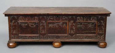 A 17th century Italian walnut pen work decorated cassone
The hinged rectangular lid above the carved