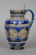 A 19th century Doulton Lambeth pottery jug
Typically decorated with silver plated rim and cover,