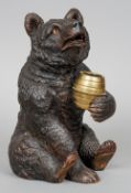 A late 19th century Black Forest carved bear form tobacco jar
The head hinged to reveal a recess,