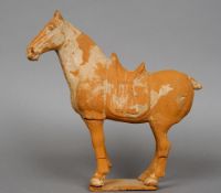 A Chinese Tang Dynasty terracotta model of horse
Of typical form, standing on all fours.  28 cm