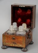 A 19th century brass inlaid rosewood decanter box
The hinged square section lid enclosing four hob