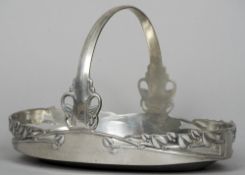 ARCHIBALD KNOX (1864-1933) British, for Liberty & Co.
An "English pewter" oval basket
With pieced