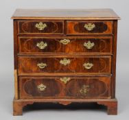 An 18th century walnut chest of drawers
The moulded rectangular top with line inlaid panel