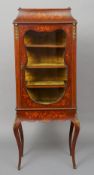 A Victorian marquetry inlaid mahogany vitrine
The three quarter brass galleried top above the glazed