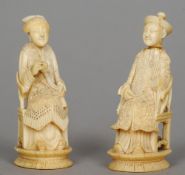 A pair of small 19th century Chinese ivory figural carvings
Each formed as a seated figure.  The