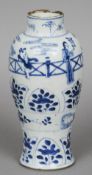 A Chinese blue and white porcelain vase
Decorated with figures in a fenced garden and lappet bands.