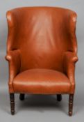 A 19th century mahogany framed porter's armchair
Of typical curved form, standing on turned legs.