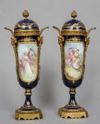 A pair of Sevres style ormolu mounted porcelain vases and covers
Each with gilt decoration on a blue