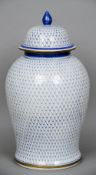 A Chinese blue and white vase and cover
With trellis work decoration, six character blue painted