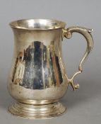 A George III silver mug, hallmarked London 1805, maker's mark indistinct
Of waisted bulbous form