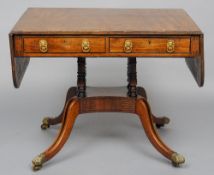 A Regency mahogany sofa table
The hinged rectangular top strung with ebony inlays above two