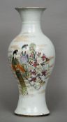 A Chinese porcelain vase
Of baluster form, decorated with female figures amongst stylised clouds and