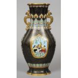 A 19th century Oriental cloisonne vase
With twin mask headed scrolling handles, decorated to one