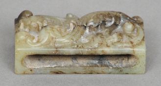 A Chinese carved jade type belt hook
Worked with a stylised dragon.  6.5 cm long. CONDITION REPORTS: