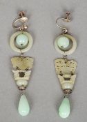 A pair of Chinese unmarked white metal mounted carved jade earrings
Each headed with a ball