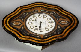 A 19th century French vineyard clock
The shaped case enclosing the enamelled dial with Roman