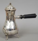 A 19th century French silver coffee pot
Of spreading baluster form with an ebony side loading