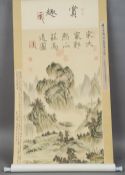 A Chinese scroll painting
Decorated with pagodas and houses in a mountainous landscape and with