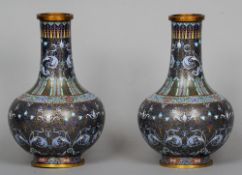A pair of Chinese cloisonne vases
Each with lappet and scrolling foliate decoration on blue ground.