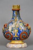 An antique Italian maiolica bottle vase
With scrolling decoration on a blue ground with devil mask