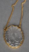 An 18 ct gold mounted carved rock crystal pendant by Ilias Lalaounis
Carved with a stylised frond,